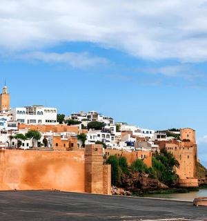 a view of a castle with a city in the background