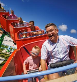 a group of people riding on a roller coaster