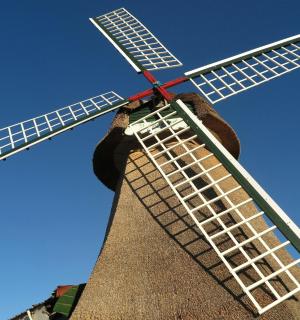 a large windmill with a red top