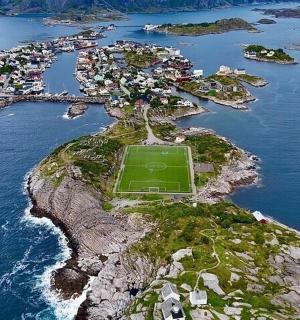 an island with a soccer field on it in the ocean