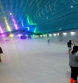 a group of people skating on an ice rink