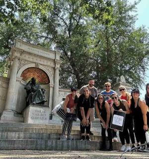 a group of people standing in front of a monument