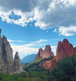 a view of a mountain range with trees and rocks