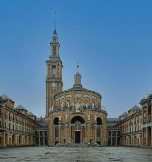 a large building with a clock tower in the distance