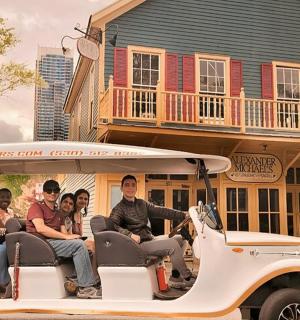 a group of people riding in a golf cart