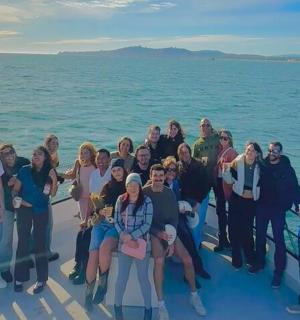 a group of people posing for a picture on a boat