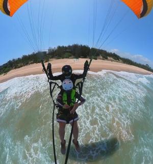 一名男子在沙滩上的水中放风筝