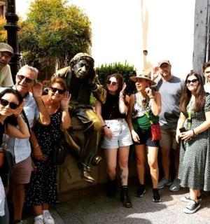 a group of people standing in front of a statue