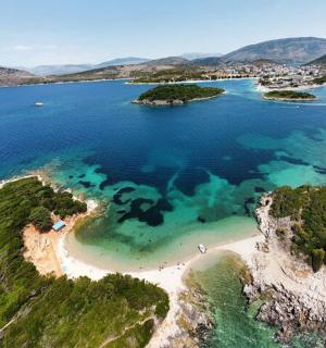 an island in the ocean with turquoise water