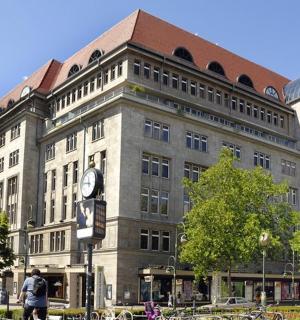 a large building with a clock in front of it