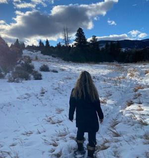 a person walking through a snow covered field