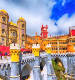 a large building with a bridge in front of it