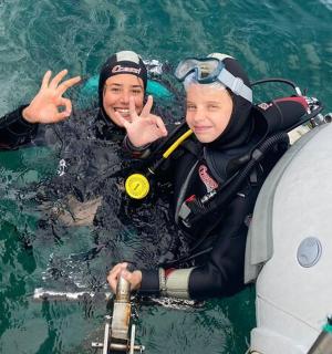 two people in the water next to a boat