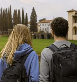 a man and woman with backpacks looking at a building