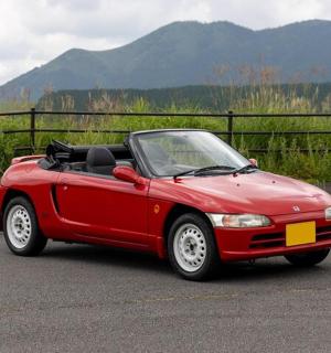 a red car is parked on the road