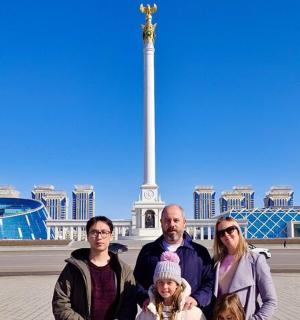 a family posing in front of the washington monument