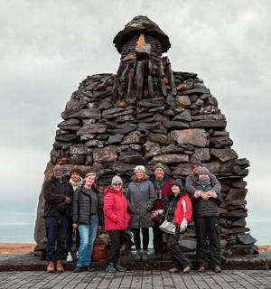 a group of people standing in front of a monument