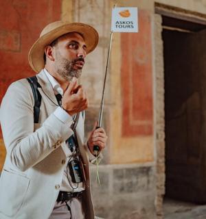 a man wearing a hat holding a sign that says none