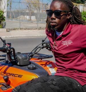 a man is sitting on an orange motorcycle