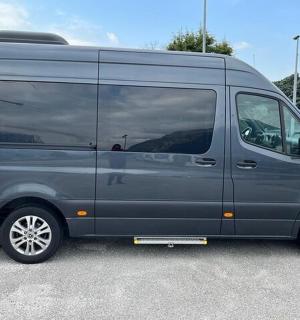 a grey van parked in a parking lot