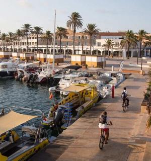a group of people riding bikes at a marina