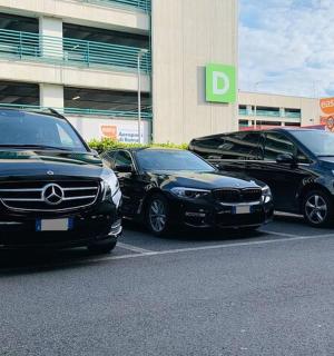 three cars parked in a parking lot in front of a building