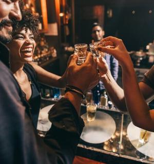 a group of people drinking at a bar