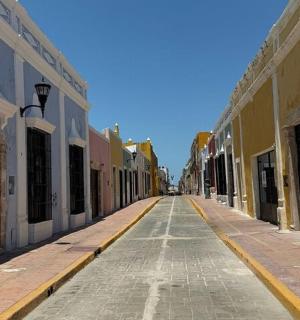an empty street in a city with colorful buildings