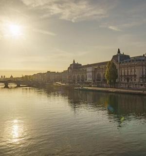 a river in a city with buildings and a bridge