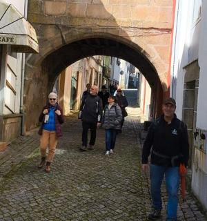 a group of people walking down an alley