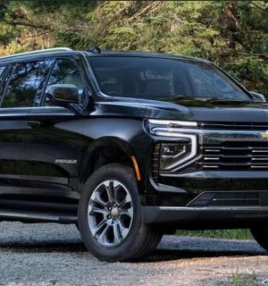 a black truck parked on a gravel road