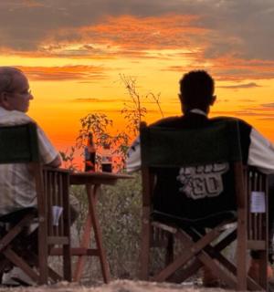 两个男人坐在桌边看日落