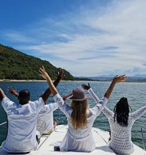 a group of people sitting on the back of a boat
