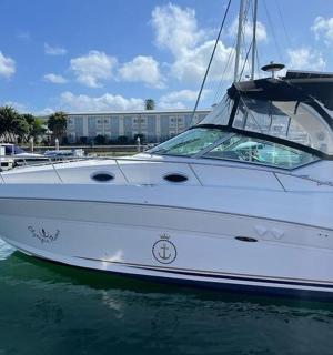 a white boat is docked in the water