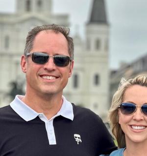 a man and a woman standing in front of a building