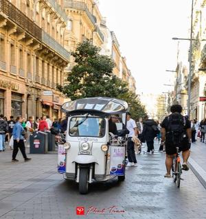 a small vehicle is driving down a city street