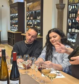 a group of people sitting at a table with wine glasses