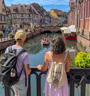 a man and a woman looking over a bridge over a river