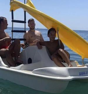 三个男人坐在水中的船上