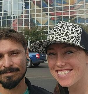 a man and a woman wearing a hat on a street
