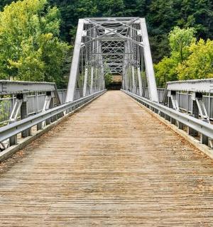 a bridge over a river with a boardwalk