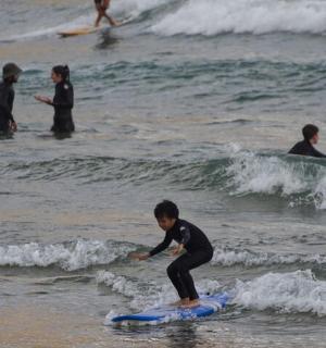 a group of people in the ocean on surfboards