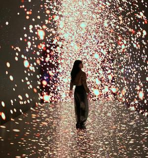 a woman standing in a tunnel of lights