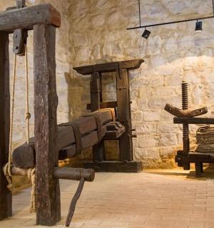 a museum with a stone wall withweapons