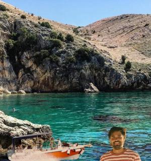 a man standing in the water next to a boat