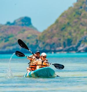 two people are in a kayak in the water
