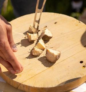 a person cutting up food on a cutting board