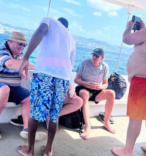 a group of men on a boat in the water