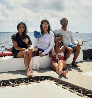 a group of people sitting on the back of a boat