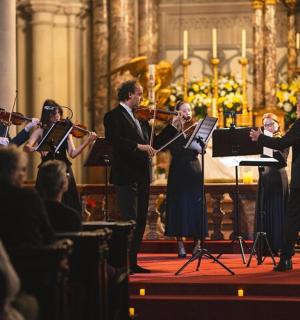 a group of people playing music in a concert